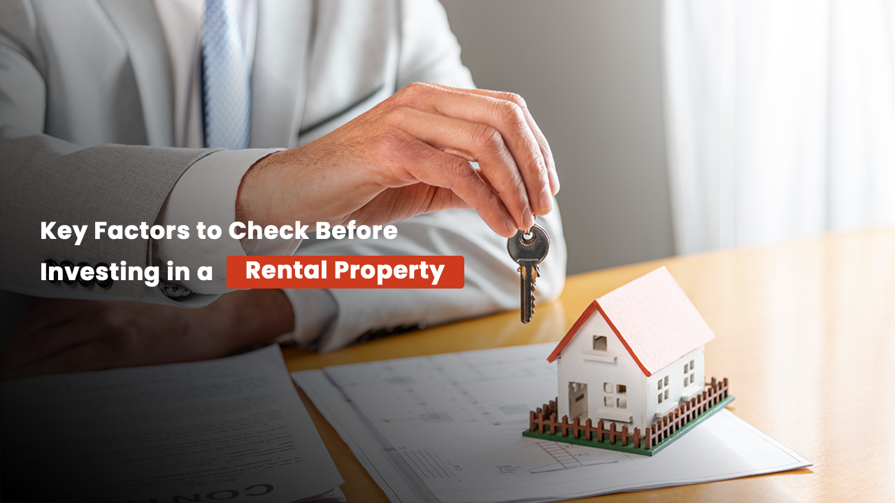 Businessman handing over house key above model home and property documents, representing essential factors like location, ROI, and connectivity to evaluate before investing in rental real estate in Ahmedabad.