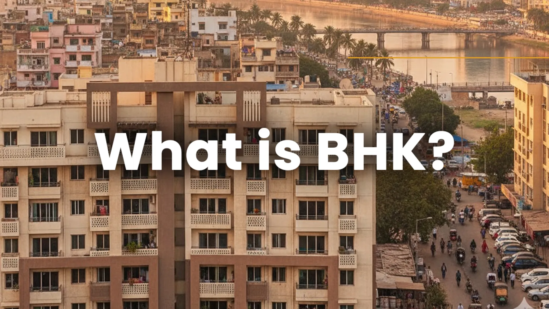 Aerial view of residential apartments in Ahmedabad with text “What is BHK?” — explaining the meaning and types of BHK flats for homebuyers in 2025.