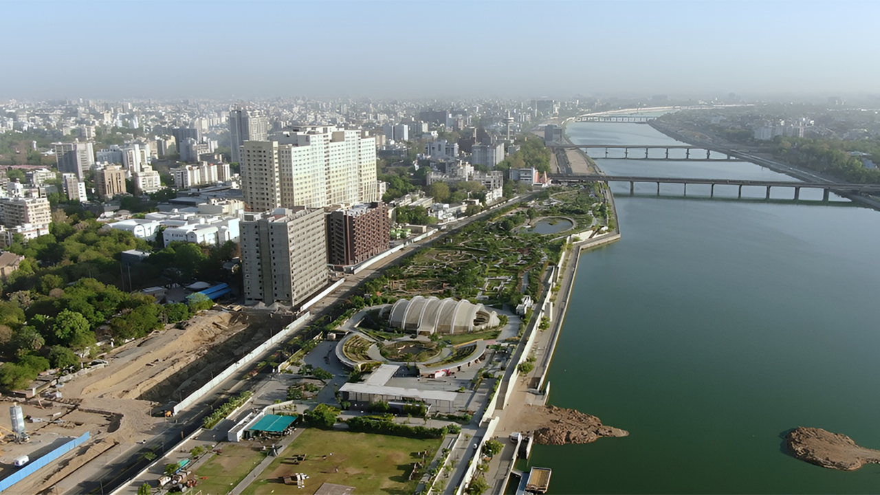 Aerial view of Ahmedabad cityscape and riverfront, highlighting urban development and rising demand for rental property investment in key areas like SG Highway and Gota