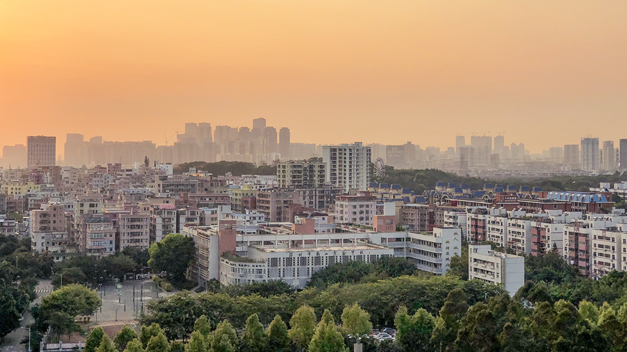 Cityscape of Ahmedabad at sunset showing high-rise buildings and residential areas, symbolizing the city's growth as a top destination for rental property investment and passive income in 2025