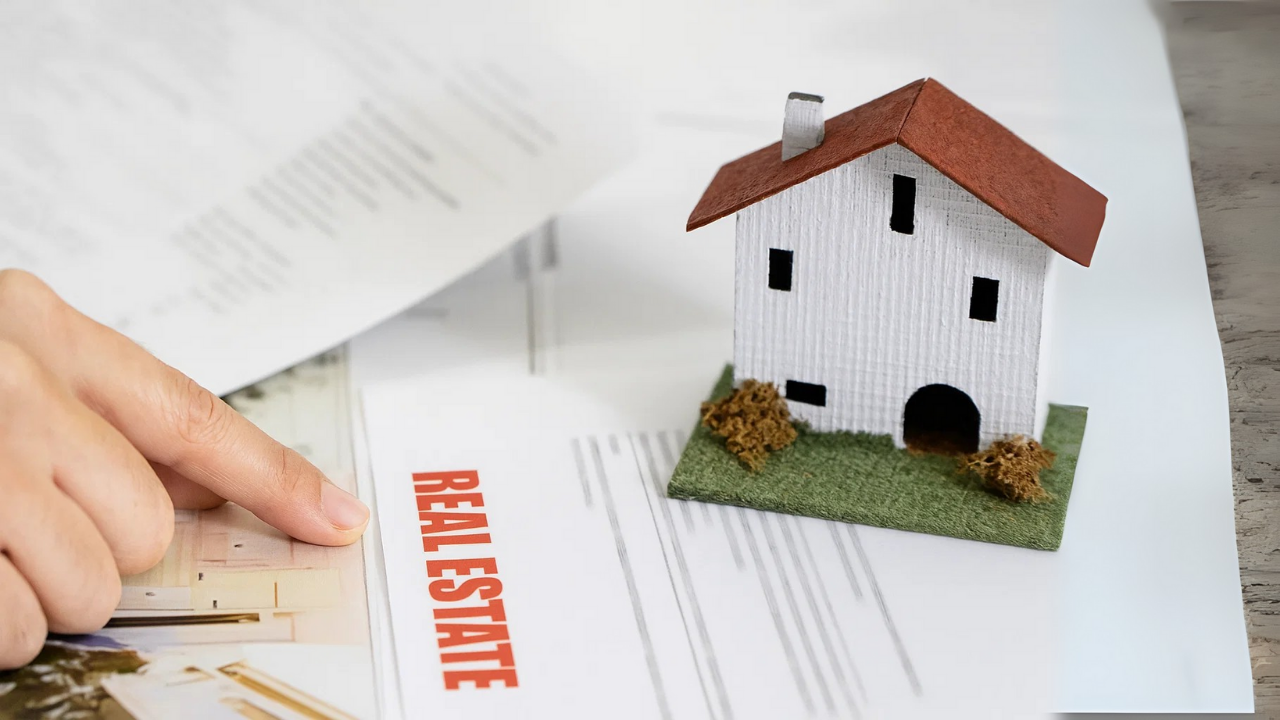 Checklist for property purchase legal check with miniature house and real estate documents showing legal paperwork for buying property