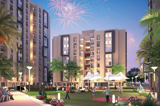 Vibrant residential community with landscaped garden, people socializing, and fireworks in the sky at Laxmi Nivas, Ahmedabad—offering affordable 1 BHK flats under ₹20 lakh in a well-connected location.