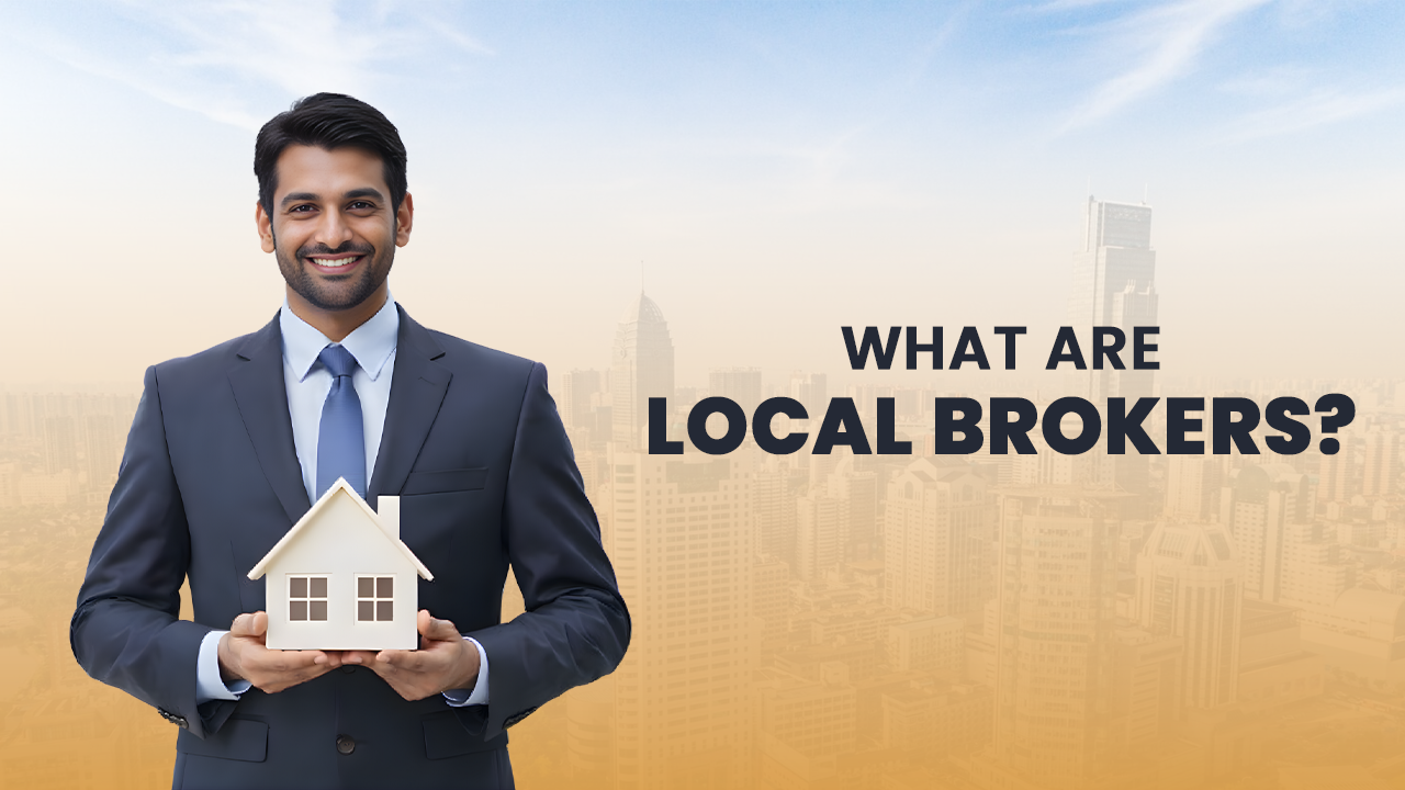 Smiling real estate broker in a suit holding a miniature house with text “What Are Local Brokers?” over a city skyline, representing the personalized service and local expertise offered by brokers in Ahmedabad’s property market.