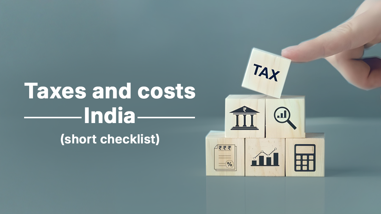 Wooden blocks stacked with tax and finance icons and the word “TAX,” illustrating investment taxes and costs in India for 2026, including capital gains, stamp duty, rental income tax, and gold and real estate taxation rules.