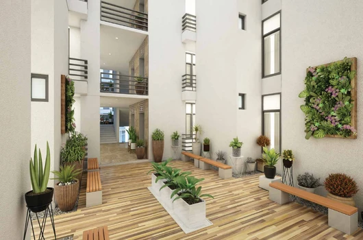 Flats in Narol Ahmedabad featuring 1 2 3 BHK apartments with modern interior courtyard, wooden flooring, indoor plants, and well-designed common seating area in a premium residential project