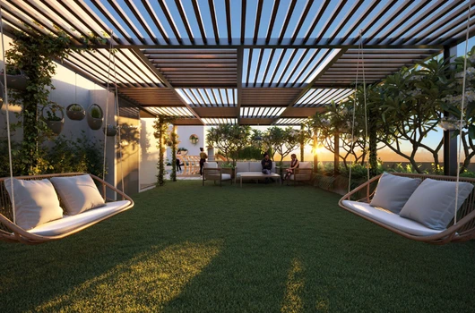 Rooftop garden with seating area and swings in a Laxmi Group apartment complex, offering modern amenities and green spaces for residents in affordable flats under 40 lakhs in Ahmedabad.