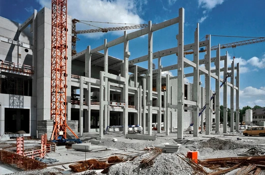 Construction site of a pre-launch residential project by Laxmi Group in Ahmedabad, showing the development of modern apartment buildings with cranes and construction materials.